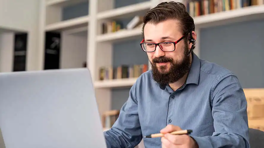 Mature man watching a webinar on his laptop.